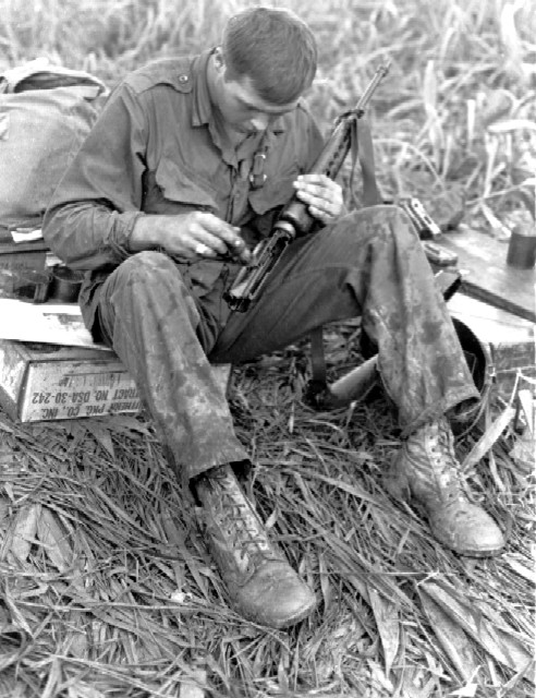 RVN, KONTUM PFC John Henson (Columbia, SC) of the 1st Battalion, 327th Infantry, 101st Airborne Division, cleans his M-16 rifle while on an operation 30 miles west of Kontum. 12 July 1966